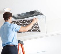 Man cleaning air ducts in home.